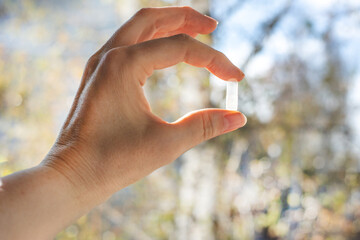 Close-up of Woman's Hand Holding Pill Capsule