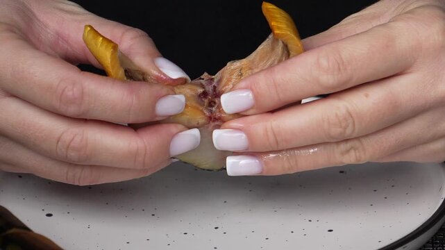  Smoked mackerel close-up. Delicious smoked fish close-up, the process of preparing it for eating. Cold-smoked fish.
