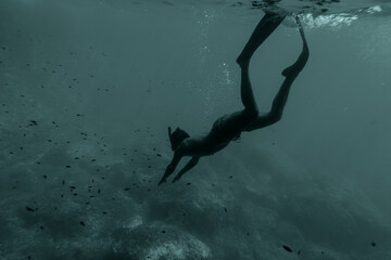 man swim underwater in snorkel. Male swimming in blue sea lagoon