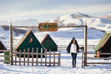 woman play with snow at ski resort camp with happy face. Winter snowy mountains background