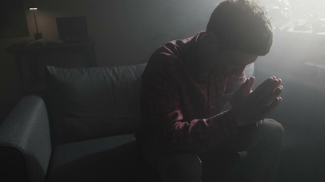 Man praying and asking God for help at night