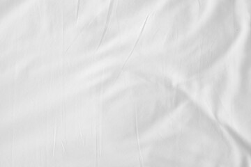Obraz premium Abstract White Bedding Sheets or White wrinkled fabric background texture and Texture with copy-space :Creased or wrinkled white fabric,Soft focus