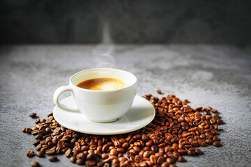 Coffee cup and coffee beans on gray background, Espresso crema coffee cup aromatic