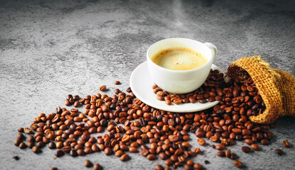 Coffee cup and coffee beans in sack on gray background, Espresso crema coffee cup aromatic