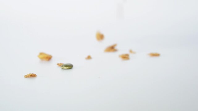Granola grains and Almonds bean fall on white background. Food for energy breakfast, brunch snack. Healthy ingredients food contains antioxidants nutrients protein, vitamins. Footage Grains nutrition 