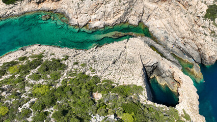 Aerial drone photo of scenic fjord shaped rock with crystal clear emerald sea ideal for snorkeling...