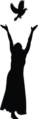 Silhouette of a person releasing a dove into the sky