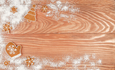 Christmas cookies and powdered sugar on a wooden table background with empty copy space for festive text or holiday design. top view