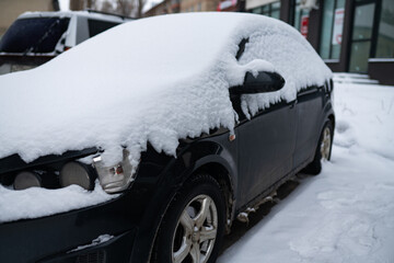 Parked frozen car covered snow after heavy snowfall and blizzard