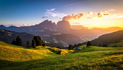 A stunning vista of rolling green hills beneath majestic, jagged mountain peaks. The warm hues of a sunrise paint the sky