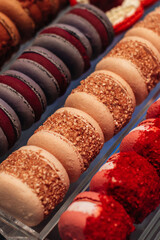 Lots of sweet delicious colourful macarons on the counter, sweet food and dessert for the holidays