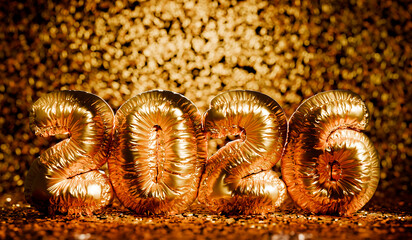 Happy New Year 2026 party celebration with golden balloons on bokeh background. Merry Christmas 3d gold number balloons in studio with confetti on black backdrop.
