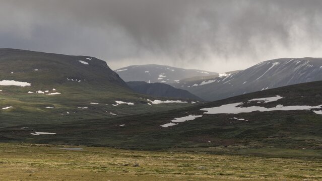 Lonely plateau with snowfields, low clouds, Kongevegen or King's Road, Olavsleden pilgrimage route, Dovrefjell, Oppdal municipality, Tr&oslash;ndelag county, Norway