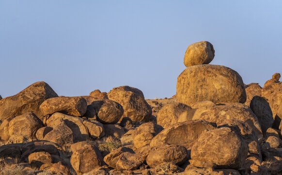 Round spherical rocks, stacked into hills, in the evening light at sunset, Brandberg, Damaraland, Erongo, Namibia