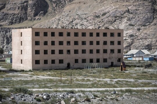 Abandoned, destroyed residential buildings, old Soviet apartment blocks in the ghost town, Engilchek, Tian Shan, Kyrgyzstan