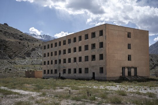 Abandoned, destroyed residential buildings, old Soviet apartment blocks in the ghost town, Engilchek, Tian Shan, Kyrgyzstan