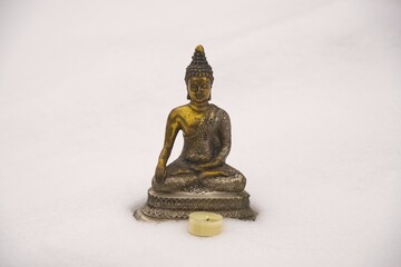 Bhumispara-mudra: Buddha Gautama in the moment of enlightenment, statue in the snow, Oytal, Allgaeu, Bavaria, Germany