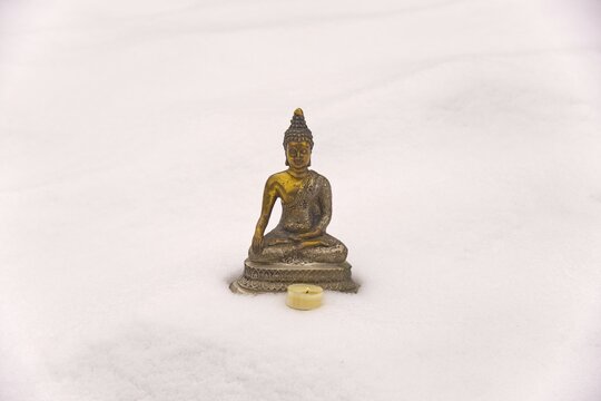 Bhumispara-mudra: Buddha Gautama in the moment of enlightenment, statue in the snow, Oytal, Allgaeu, Bavaria, Germany