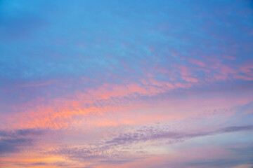 Beautiful sunset or sunrise sky with vibrant clouds changing from purple to orange is perfect for an abstract or nature background.