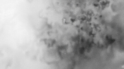 Dense cloud of smoke or fog creates mysterious atmosphere with its swirling patterns and varying shades of gray