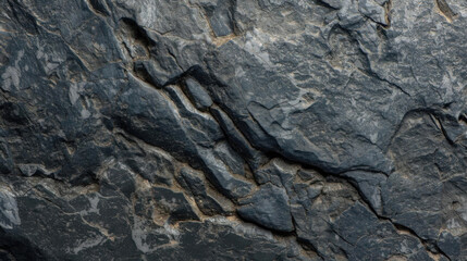 Rugged, textured rock surface with visible cracks and layers, showcasing natural geological formations