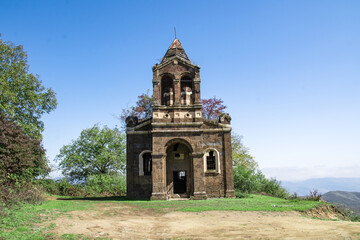 Naklejka premium An old church in nature. A Greek church in Armenia. The architecture of an old monastery. An old temple with beautiful architecture. Beautiful nature