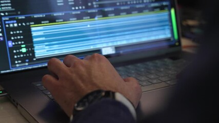Close-up shot of a hand editing video on a laptop with professional software - Powered by Adobe