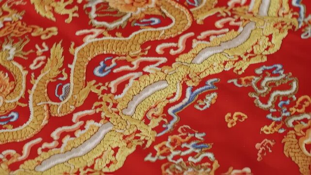 Golden dragon pattern on red silk fabric