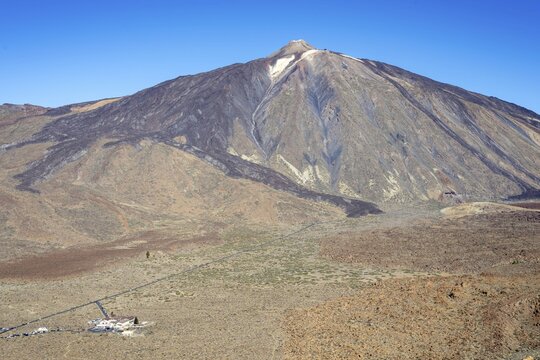 Panorama during the ascent to the Alto de Guajara, 2715m, to the bizarrely shaped rock formations of volcanic rock, Roques de Garc&iacute;a, the visitor centre and the Hotel Parador, behind it the Pico del Teide, 3717m, at sunrise, Teide National Park, Parque Nacional del Teide, Tenerife, Canary Islands, Spain