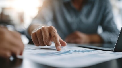 Business professionals analyzing financial charts and data during a meeting