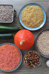 Assortment of various healthy fruits, vegetables, grains and legumes. Top view, wooden background.