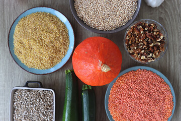Assortment of various healthy fruits, vegetables, grains and legumes. Top view, wooden background.