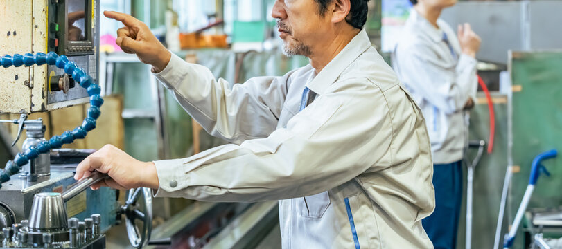 Male worker operating a machine in a factory