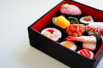 Sushi assortment set made from cloth with a white background	