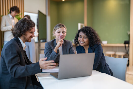Diverse tech team meeting on software project, mentor guiding coworker on laptop, teamwork development using collaboration tools, modern technology, app design, dev training and enterprise SaaS team - Powered by Adobe