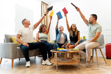 Group of friends celebrating success holding books