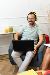 Man smiling enjoying remote work listening music