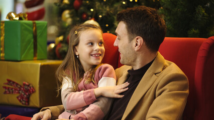 Father and daughter share a special moment during the Christmas season