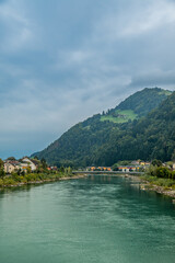 Fototapeta premium Hallein town and Salzach River with alpine hillside 