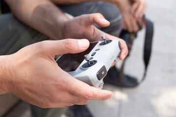 A man holds a drone remote control.