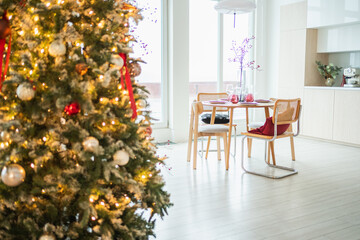 Classical Christmas decorated interior kitchen. Modern classic style interior design apartment dining room and Christmas tree with red golden ornament decorations. Christmas eve at home