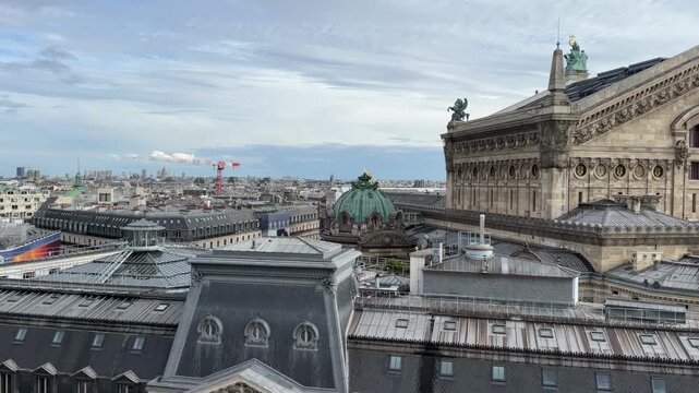 A stunning, high-angle panoramic view of the Parisian skyline on a bright, cloudy day,