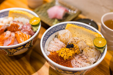 Colorful chirashi sushi with salmon shrimp scallop and uni