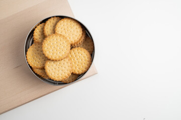 Cookies in a metal box on a light background. Homemade cookies in eco-friendly packaging. Composition for branding, delivery, or catering concepts. Sweet snack.
