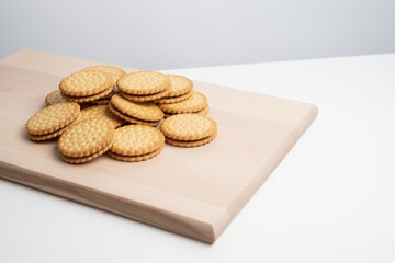 Sandwich cookies, cookies with chocolate cream filling in a crust. A modern cookie and packaging concept. A sweet snack and holiday concept.
