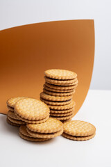 Sandwich cookies, cookies with chocolate cream filling in a crust. A modern cookie and packaging concept. A sweet snack and holiday concept.
