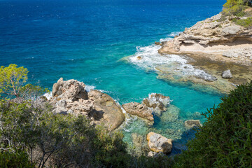 This landscape photo was taken in Europe, Greece, Peloponnese, in summer. It shows the coast at Stoupa, under the Sun.
