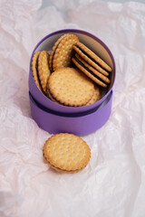 Cookies in a craft box on a light background. Homemade cookies in eco-friendly packaging. Composition for branding, delivery, or catering concepts. Sweet snack.