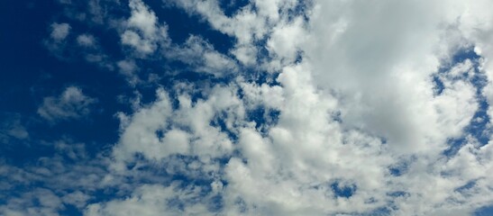 Blue Sky with White Fluffy Clouds on Sunny Day