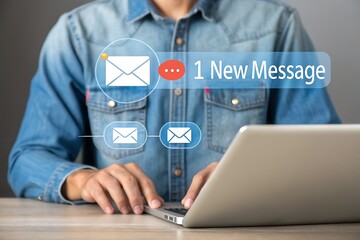 Person using laptop with new message notification on screen